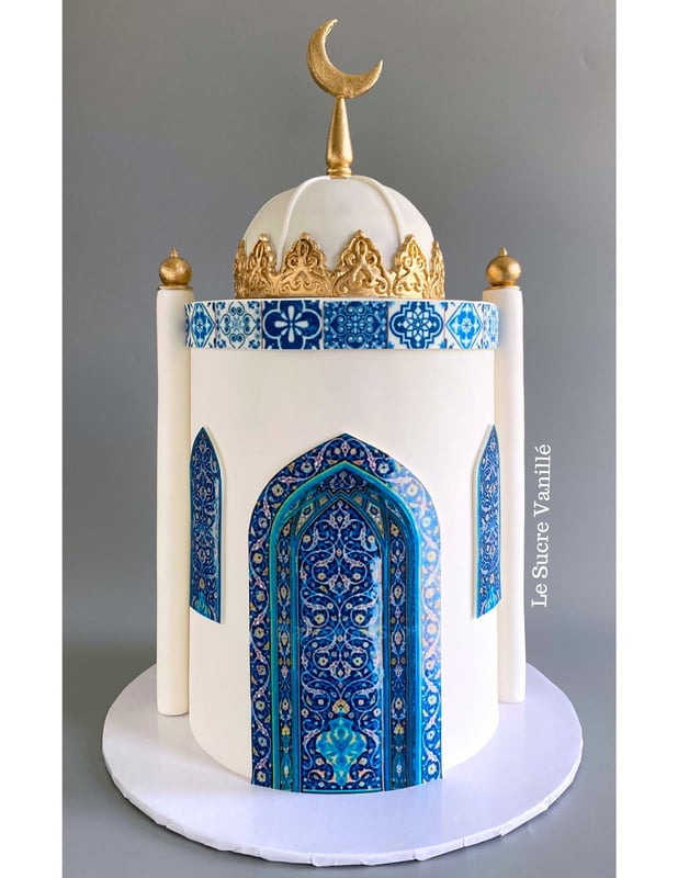 Islamic themed cake decorated with blue and white tiles and a crescent moon