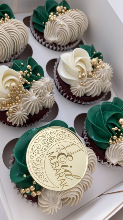 green and gold cupcakes in a white box